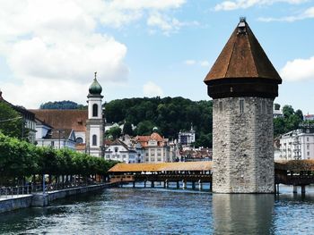 View of river amidst buildings against sky