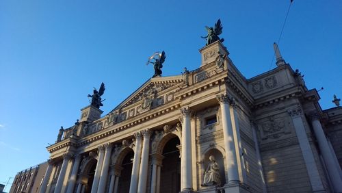 Low angle view of historical building against blue sky