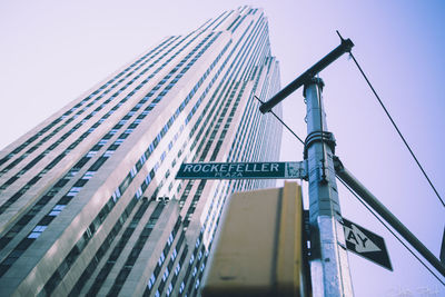 Low angle view of road sign against clear sky