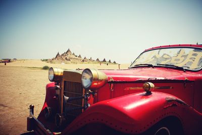 Red cars against clear sky