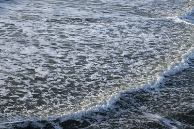 High angle view of waves rushing towards shore