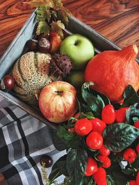 Directly above shot of fruits and vegetables in container on table