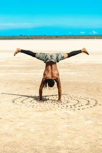 Full length of woman standing at beach