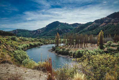 Scenic view of lake and mountains against sky