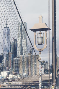 Street light in city against sky