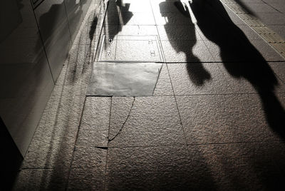 Shadow of people on footpath