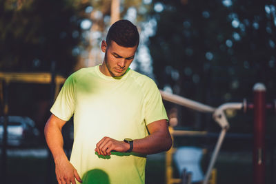 Side view of young man exercising in gym