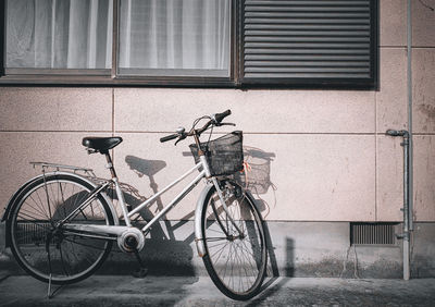 Bicycle leaning against wall