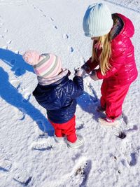 Sisters having fun in the snow- family love