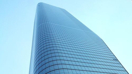 Low angle view of skyscrapers against blue sky