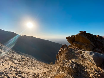 Scenic view of mountains against bright sun