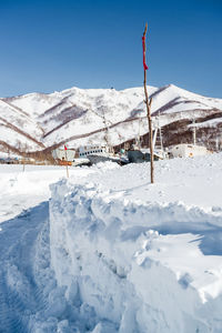 Scenic view of snowcapped mountains against blue sky