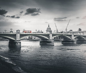 View of bridge over river against cloudy sky