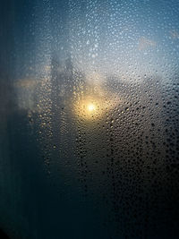 Close-up of raindrops on glass window