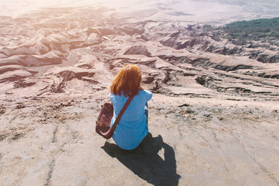 Woman sitting on land