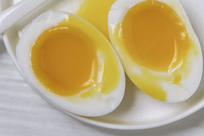 High angle view of yellow eggs in bowl on table