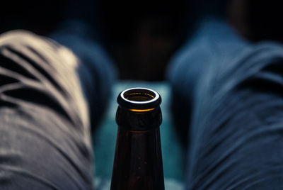 Low section of man holding beer bottle