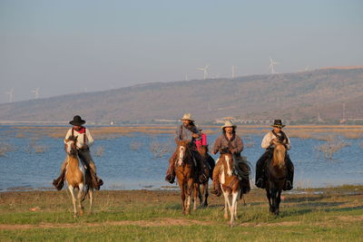 People riding horses on a field