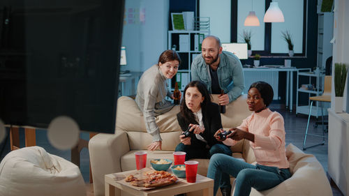 Cheerful colleagues playing games after office hour