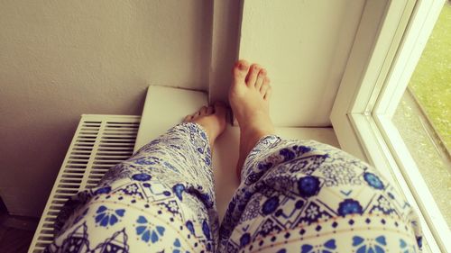 Low section of woman on tiled floor