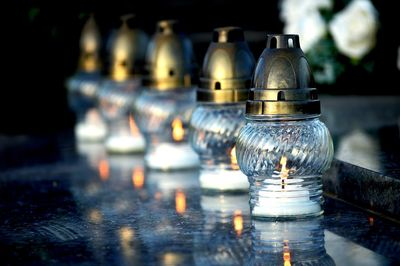 Lit lanterns in row on table