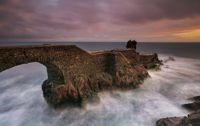 Scenic view of sea against cloudy sky