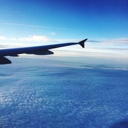 Cropped image of airplane flying over landscape