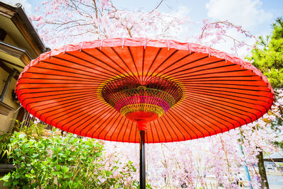 Low angle view of red umbrella against sky