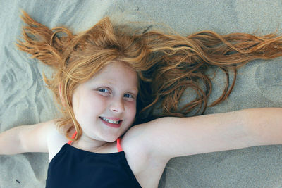 High angle portrait of happy girl at beach