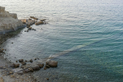 High angle view of rocks on sea shore