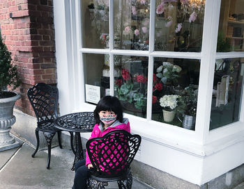 Portrait of girl sitting in front of window