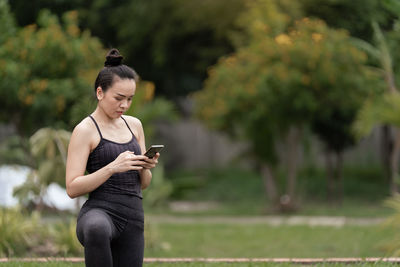 Young woman using mobile phone outdoors