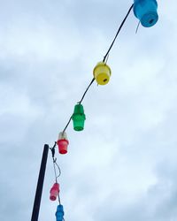 Low angle view of balloons against blue sky