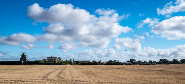 Panoramic view of field against sky
