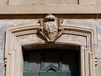 Low angle view of statue against building