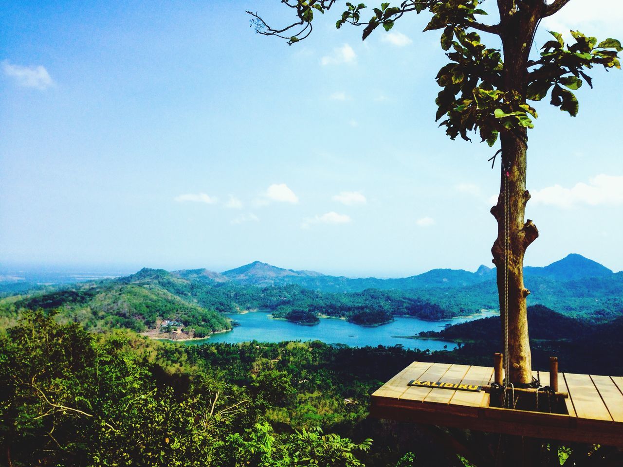 mountain, mountain range, sky, tranquil scene, scenics, tranquility, beauty in nature, tree, nature, landscape, built structure, water, building exterior, house, idyllic, lake, cloud - sky, sea, architecture, day