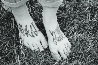 Low section of woman standing on grass