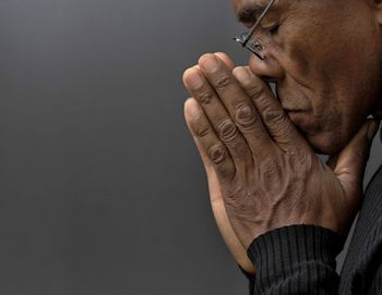 Low section of man against black background