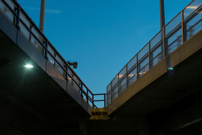 Low angle view of bridge against clear blue sky at dusk