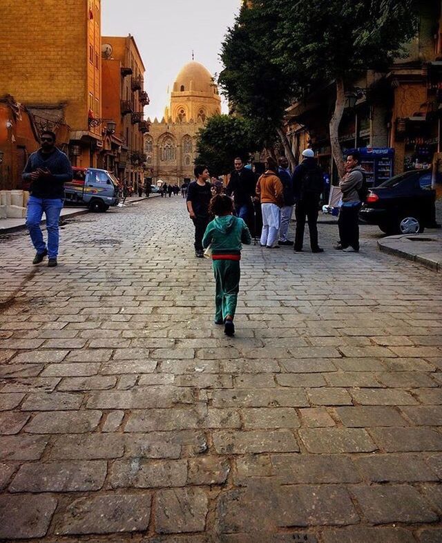 street, city, walking, built structure, architecture, people, outdoors, adult, adults only, place of worship, sky, day