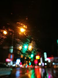 Close-up of illuminated city road at night