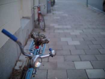 Close-up of bicycle on street in city