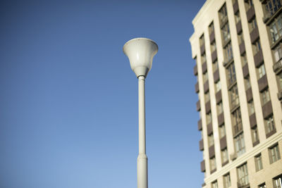 Pole with lamp against sky. lighting fixture in city. infrastructure details.