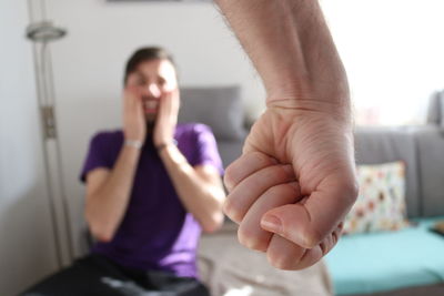 Midsection of woman sitting at home