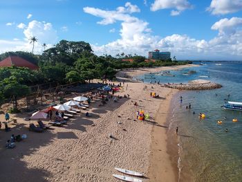 People on beach against sky