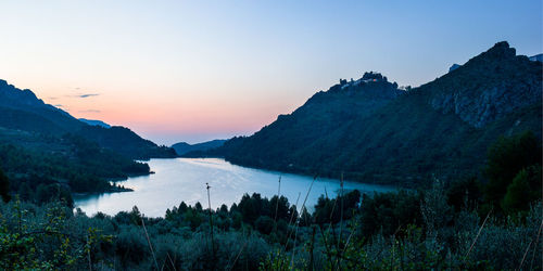 Scenic view of lake against sky during sunset