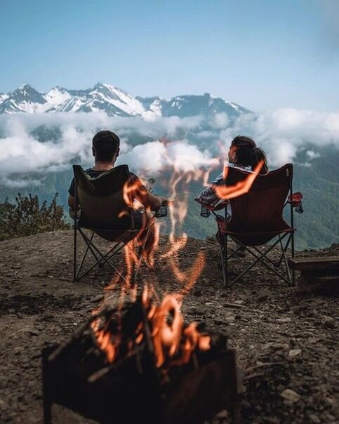 REAR VIEW OF TWO MEN SITTING ON BARBECUE