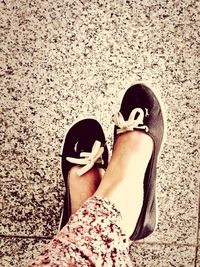 Low section of woman standing on tiled floor