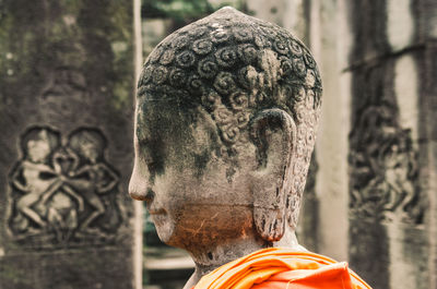 Stone statue of a seated buddha in a temple in cambodia. 