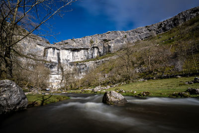 Scenic view of waterfall against sky